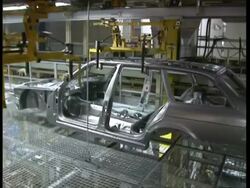 MS Car chassis carried by machine in factory Stock Footage