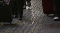 Commuters hurriedly roll luggage across a train platform in Beijing, China. Stock Footage