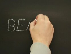 Writing 'Believe' on the school blackboard Stock Footage
