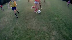 A soccer player attempts to get the ball away from an opponent but fails. Stock Footage