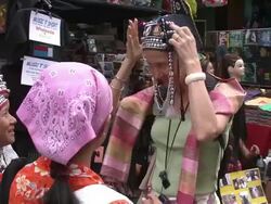 MS Woman in traditional hat photographing self with female market vendors, Bangkok, Thailand Stock Footage