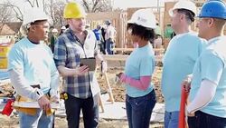 Team of volunteers working on home for charity meet with construction foreman Stock Footage