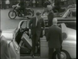 May 6, 1961 FILM MONTAGE CU John F. Kennedy in back of car/ WS Motorcade/ MS Kennedy getting out of car/ Kennedy greeting crowd/ Kennedy getting into car and leaving/ London, England Stock Footage