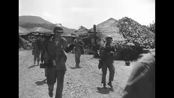 US soldiers advancing through Korean countryside during Korean War News Clip
