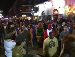 Medium Shot High Angle - People milling about Bourbon Street at night / New Orleans Louisiana Stock Footage