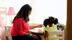 MS Mother working on puzzle with young daughter in bedroom Stock Footage