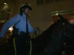 Medium Shot - Crowd of people milling about on Bourbon Street, policeman on horse rides through crowd / New Orleans Louisiana Stock Footage