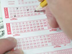 Male Hand Using a Pencil to Mark Lottery Numbers Stock Footage