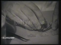 1952: MICROBIOLOGY LABORATORY: MS Male biologist, scientist, in lab working w/ tweezers. MCU Using tweezers to insert & connect small metal piece. VS Operating electron microscope, POV of microscope depicting microscopic organisms, diseases. Instructional Video