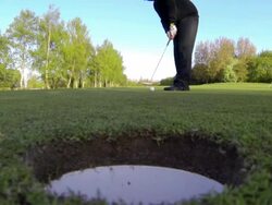 Golfers Putt From A Worms Eyed Perspective Stock Footage
