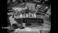 1937: BERLIN, NAZI GERMANY: WS Brandenburg Gate w/ traffic, bicycles. WS Double-decker bus (w/ trilysin hair tonic ads) toward gate. VS Outdoor cafe, well dressed people sitting at tables, waitress delivering desert, Nazi flag hanging BG. Instructional Video