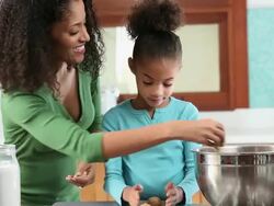 MS TU Mother and Daughter Baking Chocolate Chip Cookies in Kitchen / Richmond, Virginia, USA Stock Footage
