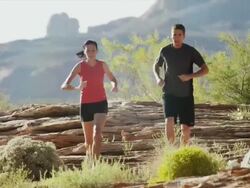 WS MS Young woman and young man jogging in desert landscape / Lake Powell, Utah, USA Stock Footage