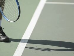 CU ECU of a man bouncing and serving a tennis ball. Stock Footage