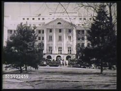 1948: THE GREENBRIER LUXURY RESORT: WS North entrance of The Greenbrier luxury resort building, some people walking. INT WS Guests having drinks at tables w/ window garden view. VS African American bartender making Mint Julep drinks at bar. Instructional Video