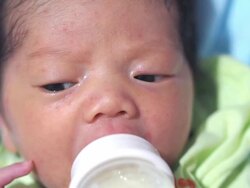 Baby infant suckling milk from bottle Stock Footage