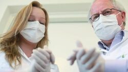 Dentist and assistant rubbing hands looking at the camera sinisterly Stock Footage