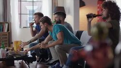 Guys sitting on couch watching tv and cheering Stock Footage