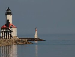 Lighthouse With Passing Sailboat Stock Footage