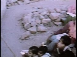 Villagers in India watch a television show. News Clip