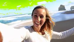 Young woman takes a selfie portrait on Gibsons steps beach Stock Footage