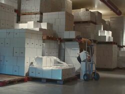 WS Man emptying boxes from hand truck in warehouse / Zillah, Washington, USA        Stock Footage