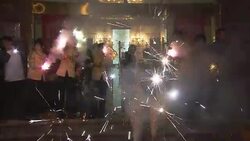 Celebrants wave fireworks and sparklers outside a storefront for Chinese New Year. Stock Footage