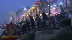 Mass bathers line the banks of a river in India. Stock Footage