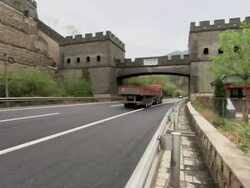Trucks driving on a highway that goes under Juyongguan Pass, which is part of the Great Wall of China. Stock Footage