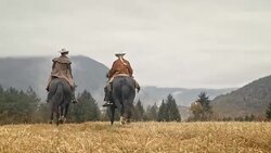 SLO MO DS Couple riding galloping horses in the mountains Stock Footage