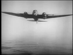 B/W 1940 AIR TO AIR airplane in flight dropping bombs / He 111 / educational Stock Footage