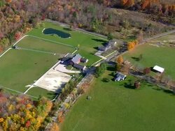 WS AERIAL ZI Wooded area with autumn colors and small houses nesting in trees / Connecticut, United States Stock Footage