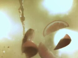 MS SLO MO Orange slices tossing up with orange juise / Los Angeles, CA, United States Stock Footage