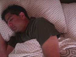 MS Man in bed sleeping, then turning over on his back / Portland, Oregon, United States Stock Footage