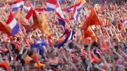 Netherlands, Amsterdam, Supporters of Dutch national football team during the World Championship 2010, watching the final against Spain on square called Museumplein. Many people dressed in orange, the national color Stock Footage