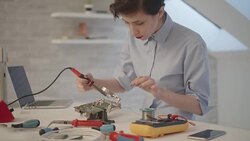 4K: Female Engineer Soldering a Circuit Board In Her Office. Stock Footage