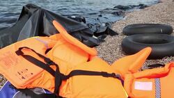 Life jackets and remains of boats left by Syrian migrants fleeing the war and escaping to Europe, landing on the Greek island of Lesvos on the north coast at Efthalou. Up to 4,000 migrants a day are landing on the island and overwhelming the authorities. T Stock Footage