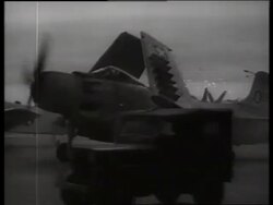 B/W 1960's off-road vehicle passing parked military airplane / Vietnam / SOUND Stock Footage