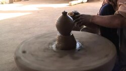 A potter molds a pot on a spinning potter's wheel. Stock Footage