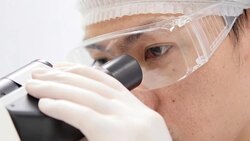 Scientist is using with microscope Stock Footage