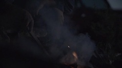 Middle-Aged Caucasian Male Stokes Campfire Stock Footage