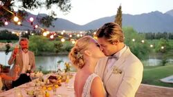 Guests toasting kissing bride and groom at wedding reception Stock Footage