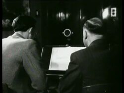 A Dutch broadcaster interviews dr. Kaskelis who talks about the atrocities of the Bolshevists in Lithuania. Kaskelis also shows pictures  Stock Footage