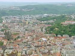 WS AERIAL View of buildings with trees and mountain / Brno, Brno City District, Czech Republic Stock Footage