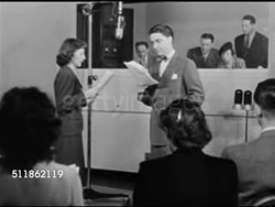 1947: REPRISAL: AUDITIONS: 'Miss Johnson' reading w/ Paul Crabtree from 'Claudia' script w/ Rose Franken & others in booth BG, MS Two seated female actors/actresses w/ scripts. MS Male in booth looking at script. Instructional Video