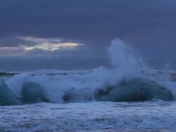 Slow motion of ocean wave smashing Iceberg stuck Stock Footage
