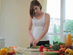 Happy woman cooking vegetables green salad Stock Footage
