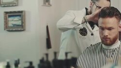 Barber cutting a mans hair Stock Footage