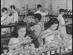 1936: COMMONWEALTH of the PHILIPPINES: UNIVERSITY: WS Building w/ tents on campus lawn, people, students walking on lawn. CHEMISTRY CLASS LAB: Female students pouring liquid, male student shaking beaker, woman reaching for bottle w/ clear liquid. Instructional Video