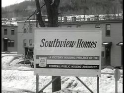 1946: SOUTHVIEW HOMES: Sign: 'Southview Homes, Victory housing project of the Federal Housing Authority' & VS of simple houses (rectangle, flat roof) built in cluster at bottom of hill. Snow on ground. Instructional Video